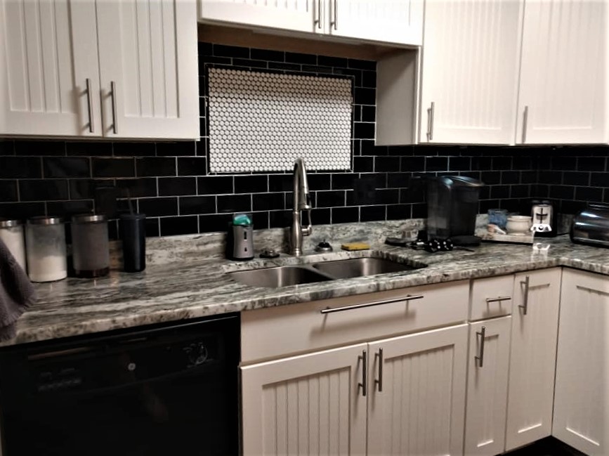 black subway tile, behind the sink, framed accent tile, penny tile, backsplash, black and white, round tile, circle tile, mosaic tile, accent tile