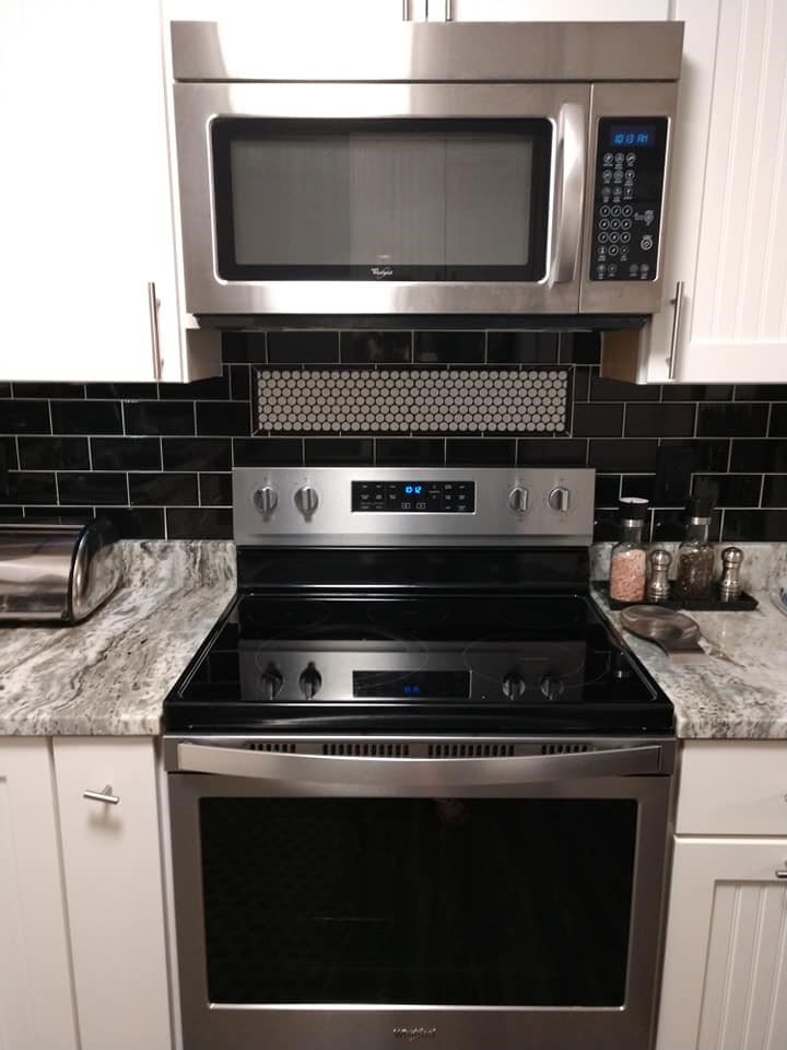 black subway tile, behind the sink, framed accent tile, penny tile, backsplash, black and white, round tile, circle tile, mosaic tile, accent tile